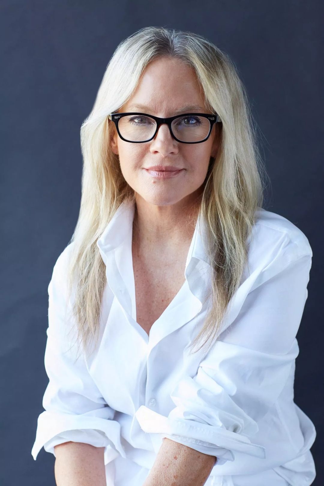 Actress Rachael Harris in a crisp white shirt and black frame glasses for People Magazine, styled by Quentin Fears